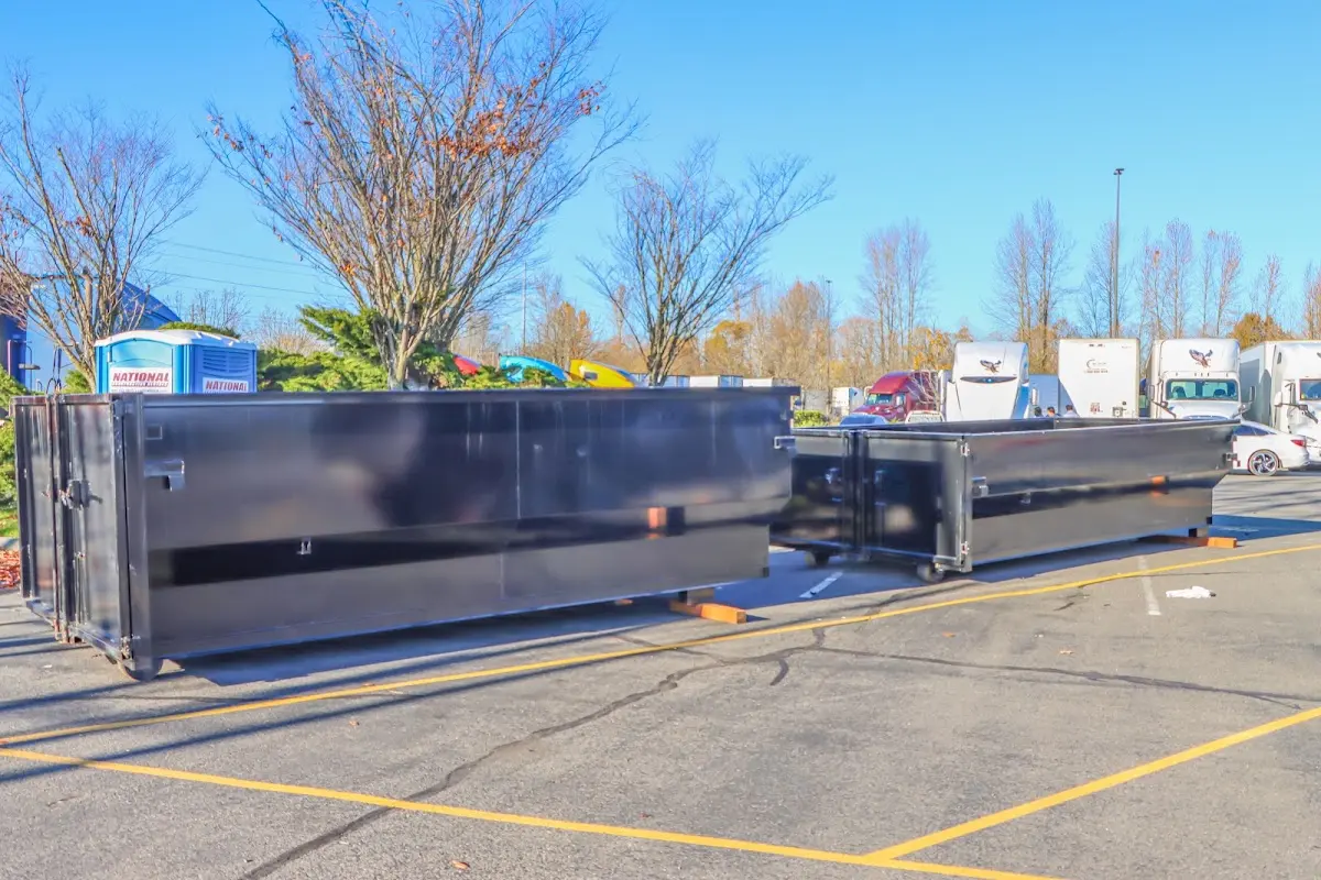 Professional dumpster rental service with roll-off container on residential driveway in West Puente Valley